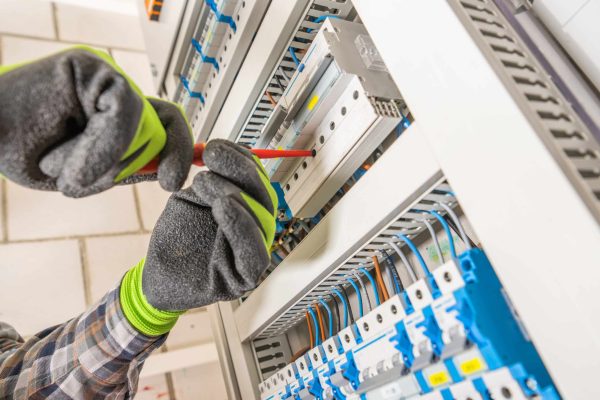 Electrician Finishing Electric Board Installation Close Up. Residential Electricity Fusebox.